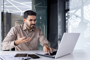 Idle computer, broken laptop at workplace, unhappy angry businessman at workplace shouting unhappy...