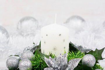 Christmas decoration with candle, fir branch and silver balls on white background