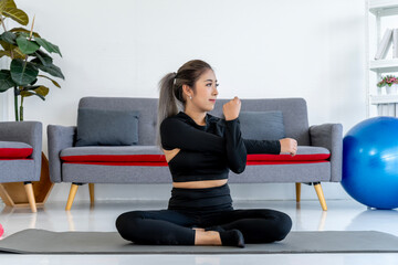 Asian Woman Stretching Arms on Yoga Mat