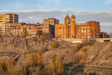 Capital Armenia. Sights Yerevan. Cityscape with rocks. Surb Sarkis church. Architecture of Armenian cities. Yerevan on summer day. Vicar church on river bank. Tour in Armenia. Excursions, travel