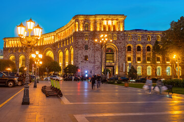 Sights Armenia. Night Yerevan. Republic square in capital. Pedestrians walk around Yerevan....