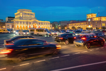 Cityscape Armenia. Streets of Yerevan. Road with cars near government building. Night Armenian capital. Republic square in Yerevan. Evening city with speed effect. Auto travel in Armenia