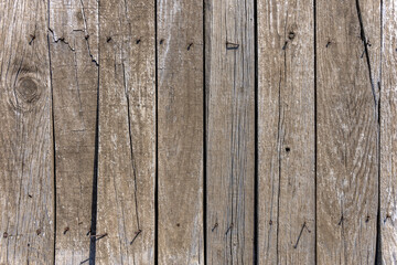 Old unvarnished wooden boards with nails sticking out in the corners