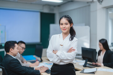 Happy confident smiling young professional Asian business woman corporate leader, Japanese female employee or company sales marketing manager standing arms crossed in office, cute girl portrait
