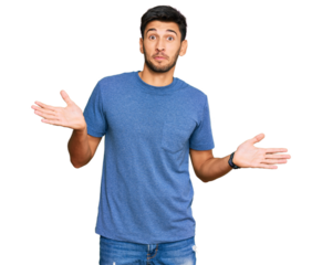 Young handsome man wearing casual clothes clueless and confused expression with arms and hands raised. doubt concept.