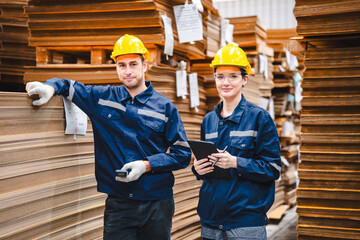 Professional worker team in safety uniform, supervisor inspector in packaging stock order at cardboard factory warehouse, piles of stacking paper manufacture, recycling industrial production