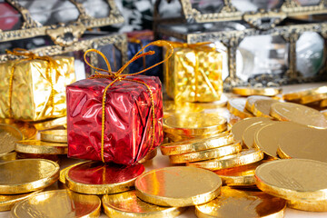 red gift boxes and a gold coin are placed against the background of New Year