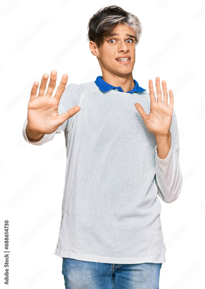 Sticker young hispanic man wearing casual clothes afraid and terrified with fear expression stop gesture wit