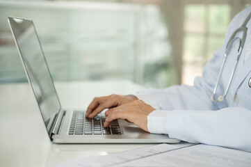 Medical Writers use computer to typing information of clinical trial documents and medical information.