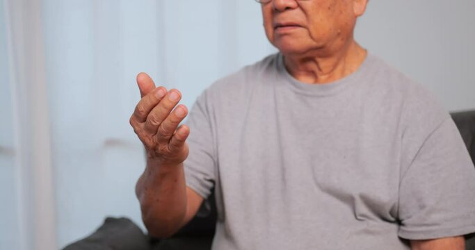 An elderly man's hand is trembling because of Parkinson's disease.