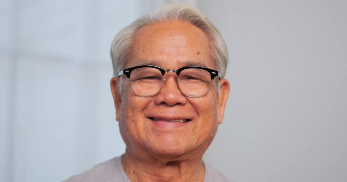 Close up, portrait of older man smiling and looking at the camera, isolated on white background.