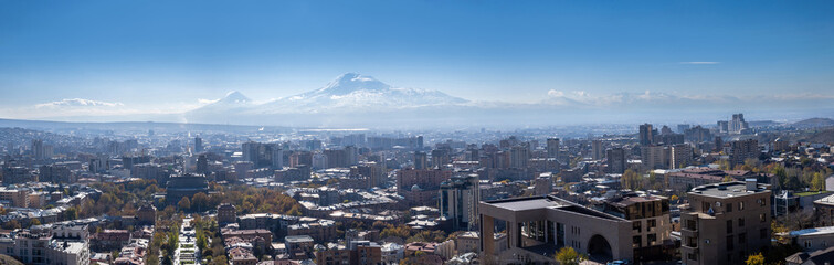 Panorama of Armenia. Summer Yerevan. View of capital of Armenia from quadcopter. High mountains behind city. Yerevan from bird eye view. Armenia cityscape. Panorama of sunny Yerevan