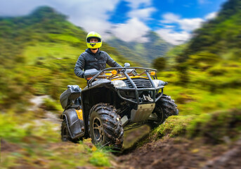 Man on ATV. Quadcyclist travels off-road. Extreme tourism. Guy nar blurred mountains. Quadcyclist...