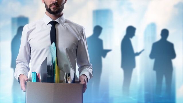 Fired man with box. Office manager lost his job. Fired businessman. Guy was left without work. Labor market crisis concept. Cropped man fired from company. Dismissed male near silhouettes of people