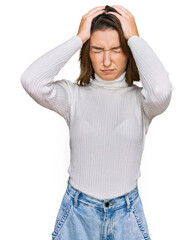 Young caucasian girl wearing casual clothes suffering from headache desperate and stressed because pain and migraine. hands on head.