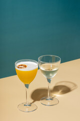 Alcoholic cocktail in two glasses on a colored background