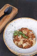 Bolognese in a bowl on a dark background top view, flat lay