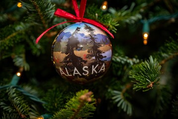 Festive Christmas ornament featuring the word Alaska