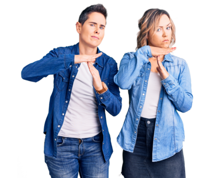 Couple of women wearing casual clothes doing time out gesture with hands, frustrated and serious face