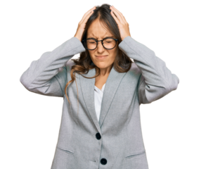 Young brunette woman wearing business clothes suffering from headache desperate and stressed because pain and migraine. hands on head.