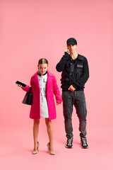 Clad in sharp suit and armed with briefcase, this little girl exudes confidence and determination, her stern expression mirroring that of her seasoned security guard.