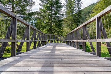Fototapeta na wymiar Wooden walking trail for recreation through the forest to the nearby hills, Bohinj, Triglav national park, Slovenia