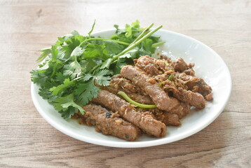 fried slice pork meat with garlic couple pepper topping parsley on plate  