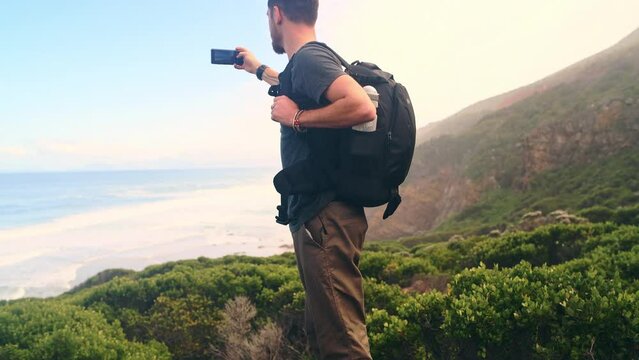 Phone photo, nature hiking and man with social media post of outdoor picture, ocean view or mountain travel in Ireland. Smartphone photography, trekking holiday and backpacker filming memory video