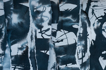 Abstract grunge black, navy blue and white backdrop with scraps of paper and black navy blue ink...