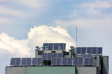 Photovoltaic, solar panels on the roof of a residential block. Production of electricity by...