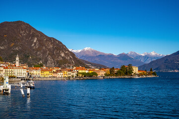 The town of Menaggio with its lakefront, its buildings, and the pier.