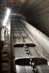 Horizontal photo of a conveyor belt in a mine. Extraction of minerals from the bowels of the earth.