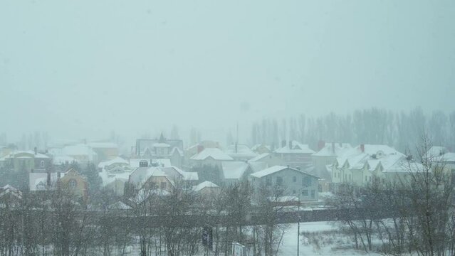 Snowfall in the town small city landscape view of the falling snow snowflakes cold winter weather