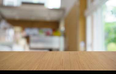 Mock up for space. Empty dark wooden table in front of abstract blurred bokeh background of...