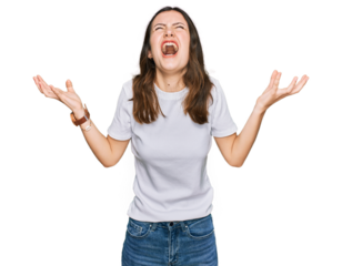 Young beautiful woman wearing casual white t shirt crazy and mad shouting and yelling with aggressive expression and arms raised. frustration concept.