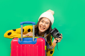 Tourist asian woman in casual clothes hat hold suitcase using mobile cell phone sit isolated on colour background Passenger travel abroad weekends . - obrazy, fototapety, plakaty
