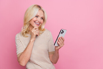 Photo of pretty lady arm touch chin use apple iphone gadget empty space isolated on pink color...