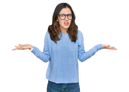 Young beautiful woman wearing casual clothes and glasses clueless and confused with open arms, no idea concept.
