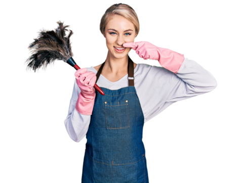 Beautiful young blonde woman wearing apron holding cleaning duster pointing with hand finger to face and nose, smiling cheerful. beauty concept - Powered by Adobe