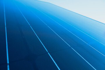 Solar panel with sunlight and blue sky background. Alternative energy ecological concept.