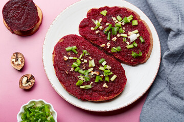 Spring beetroot spread sandwiches with spring young onion, garlic and walnuts. Vegan healthy spring food. Top view