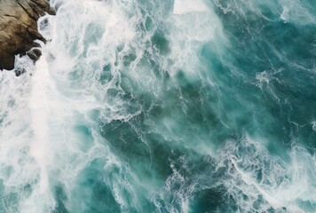 with a view of the blue water and black sand - obrazy, fototapety, plakaty