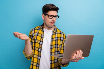 Portrait of clueless guy with stubble wear checkered shirt in glasses look at laptop found bug in...