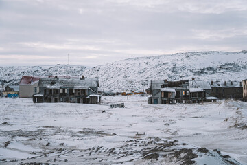 Teriberka is a village on the shore of the Arctic Ocean. The edge of the world. The far north of Russia. old fishing village on the shore of the sea. old ruined houses in winter.