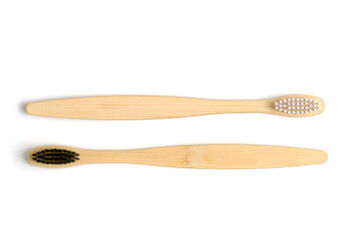 Eco friendly wooden toothbrushes with white and black bristles white background.