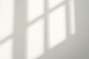 Gray shadow and light blur abstract background on white wall  from window. Dark stripe grey shadows...