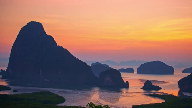 .Time lapse Amazing red sky above the island in Samed Nang Chee Phang Nga. .the flare light from the sun shines above the islands. .early sunrise at Samed Nang Chee archipelago. archipelago background