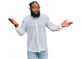 Young african american man wearing business shirt and glasses clueless and confused expression with arms and hands raised. doubt concept.