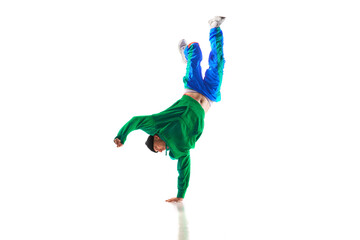 Fashionable portrait. Stylishly dressed man dancing in freestyle, breakdance style in motion...