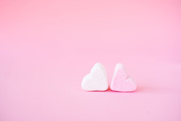 sweet heart shape of marshmallows on pink background. Decoration for love and valentine day concept.